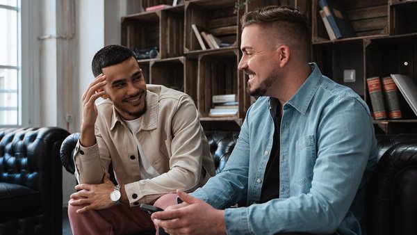 Die junge Generation und die Rente Zwei Studenten reden miteinander auf einer Couch